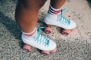 Person wearing white roller skates with pink wheels