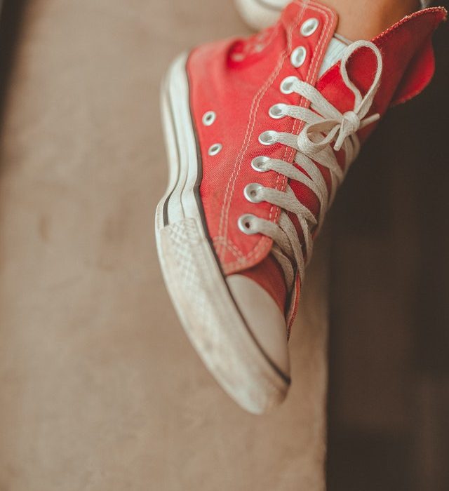 Red and white sneakers with tied laces