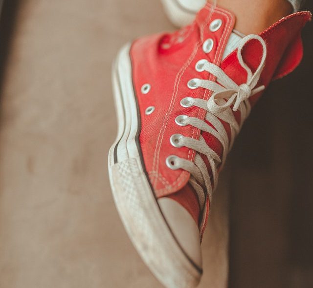 Red and white sneakers with tied laces