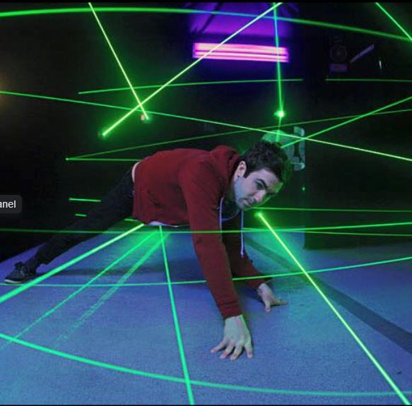 guy in hoodie attempting laser maze